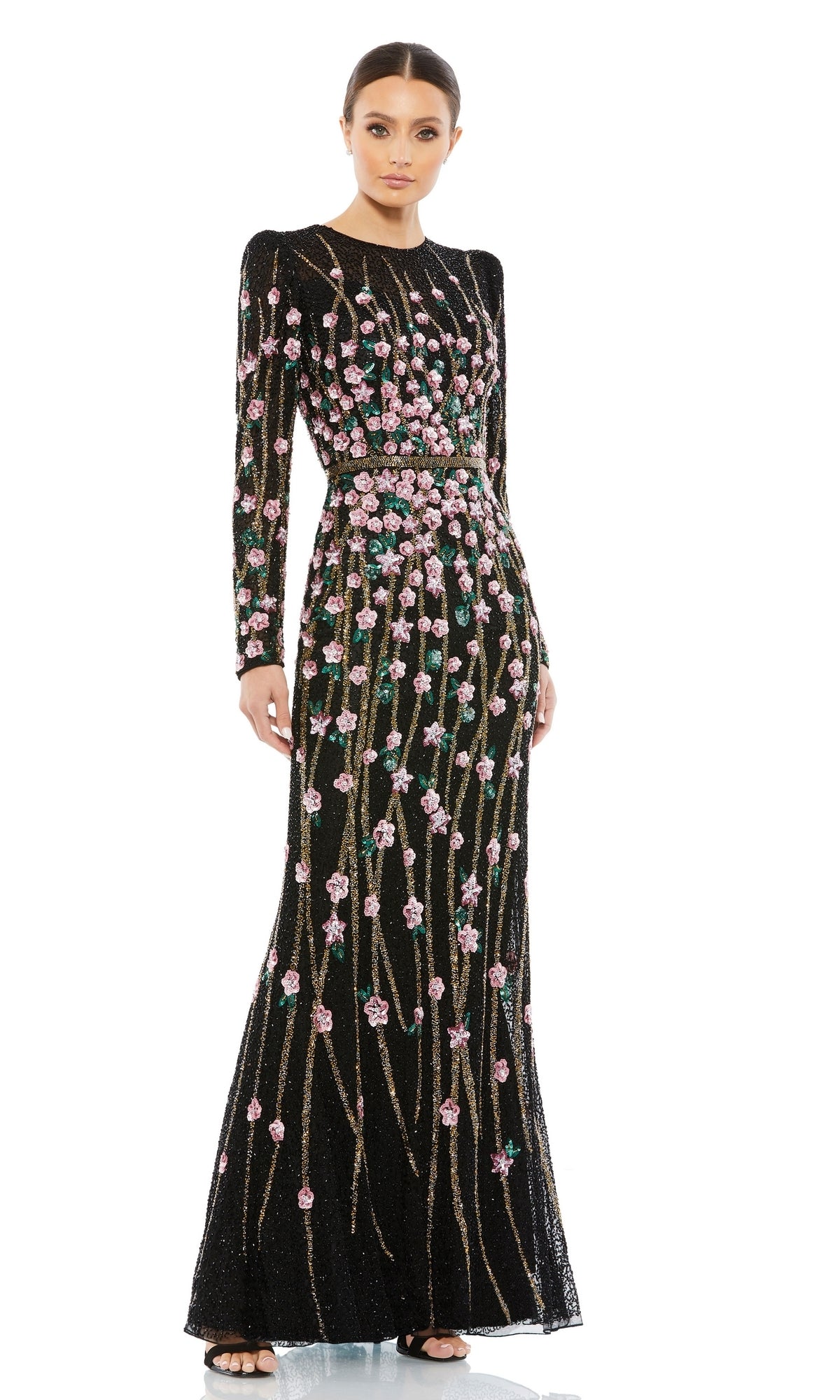 A woman stands gracefully against a white background, wearing the Beaded Long Black Formal Dress: Mac Duggal 5492, featuring long sleeves and intricate pink floral embroidery with green accents.